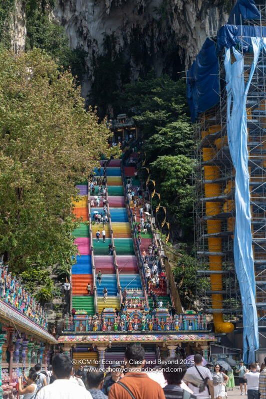 a multicolored stairs with people walking up