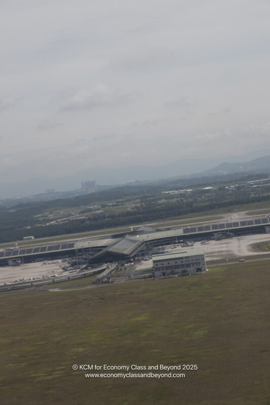 an airport with a large field and a building