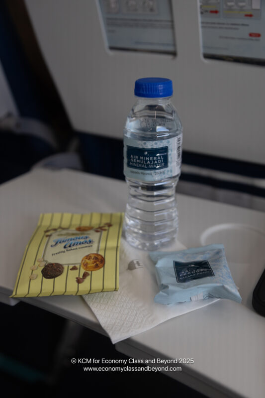 a bottle of water and a snack on a table