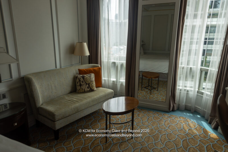a room with a couch and a mirror