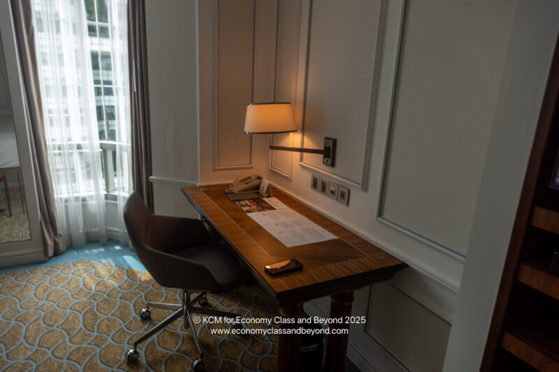a desk with a lamp and a book on it