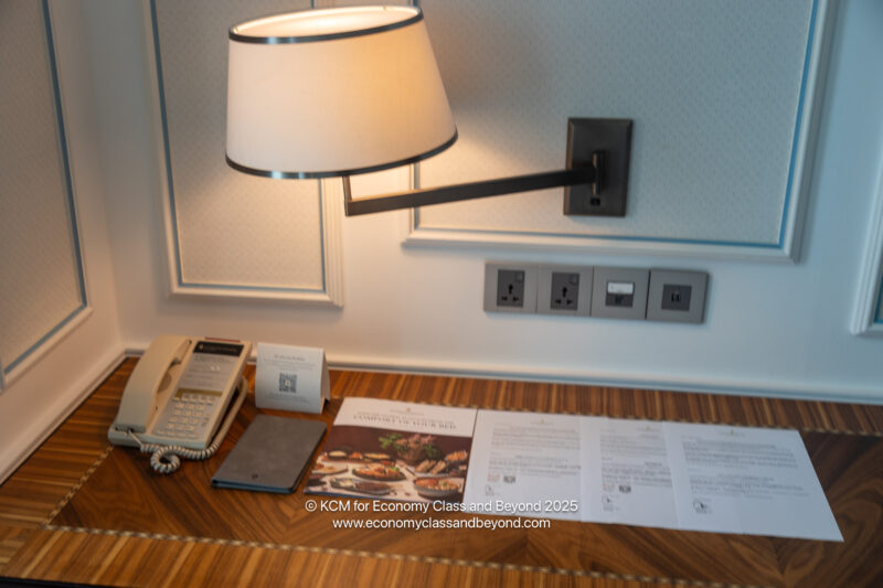 a desk with a lamp and papers on it