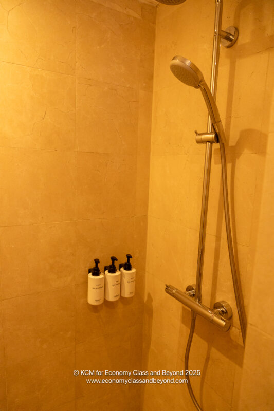a shower with soaps and a shower head