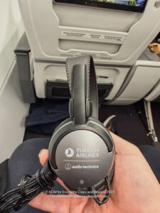 a hand holding headphones