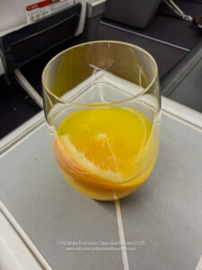a glass with orange juice and a slice of orange