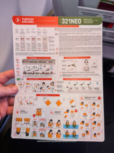 a hand holding a instruction booklet