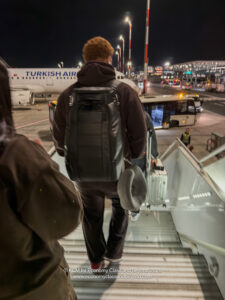 a man walking up a staircase with a backpack