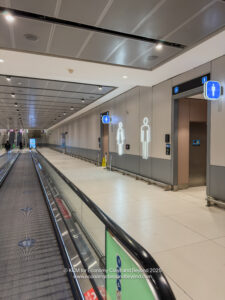 a walkway in a building with signs
