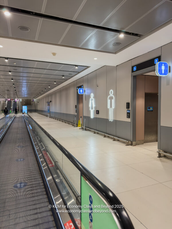 a walkway in a building with signs