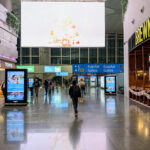 a group of people walking in a large airport terminal