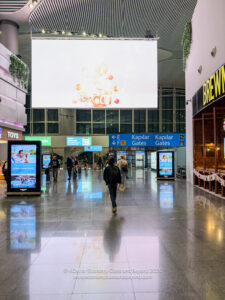 a group of people walking in a large airport terminal