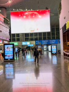 people walking in a large airport terminal