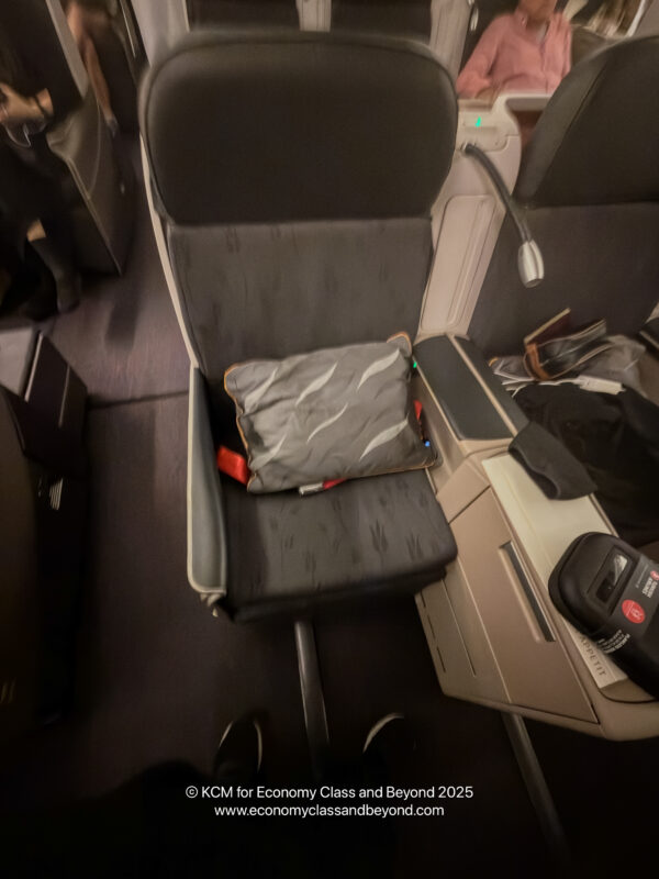 a seat with a pillow and a bag on it