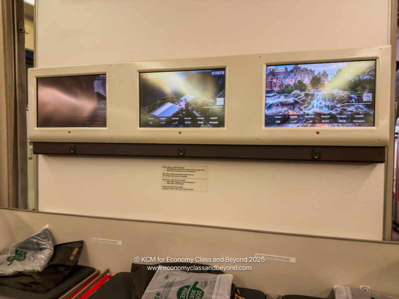 a group of screens on a wall