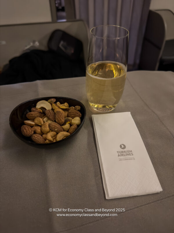 a bowl of nuts and a glass of liquid