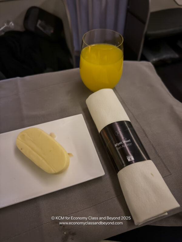 a plate of butter and a glass of orange juice