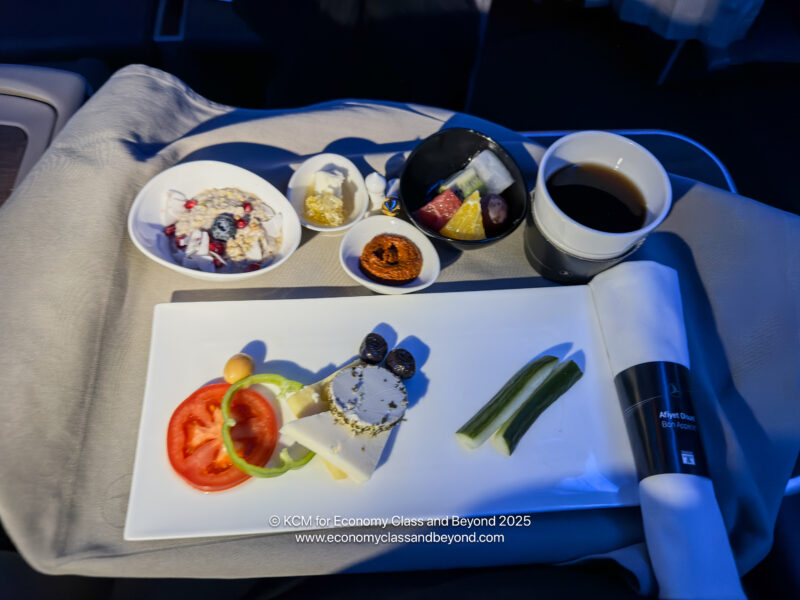 a plate of food and a cup of coffee on a tray