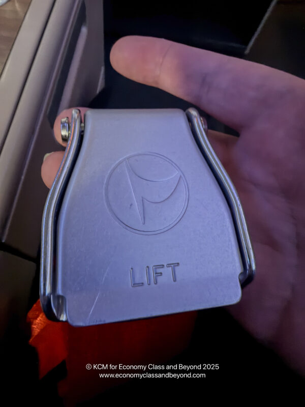 a hand holding a silver object