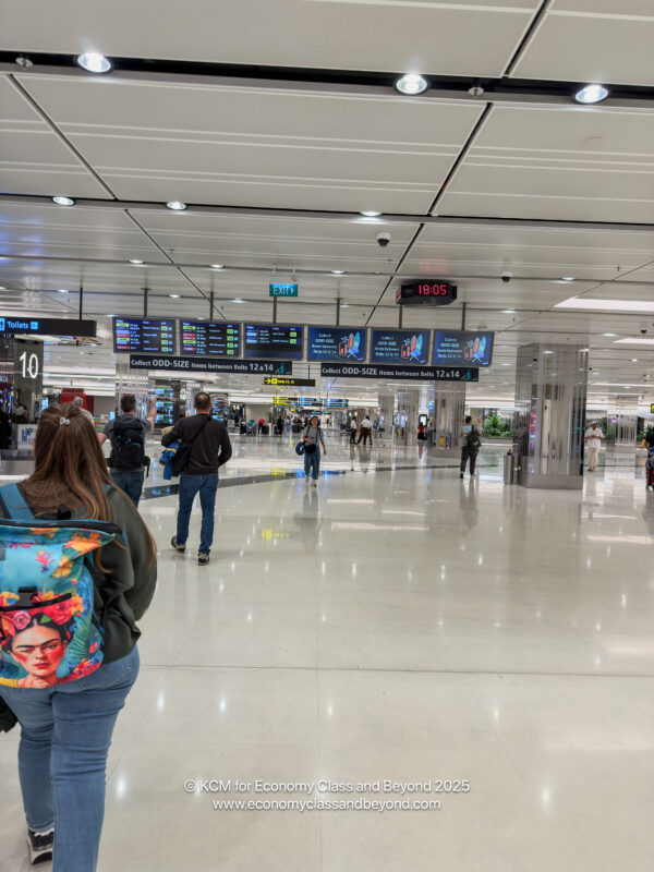 people walking in a large airport terminal