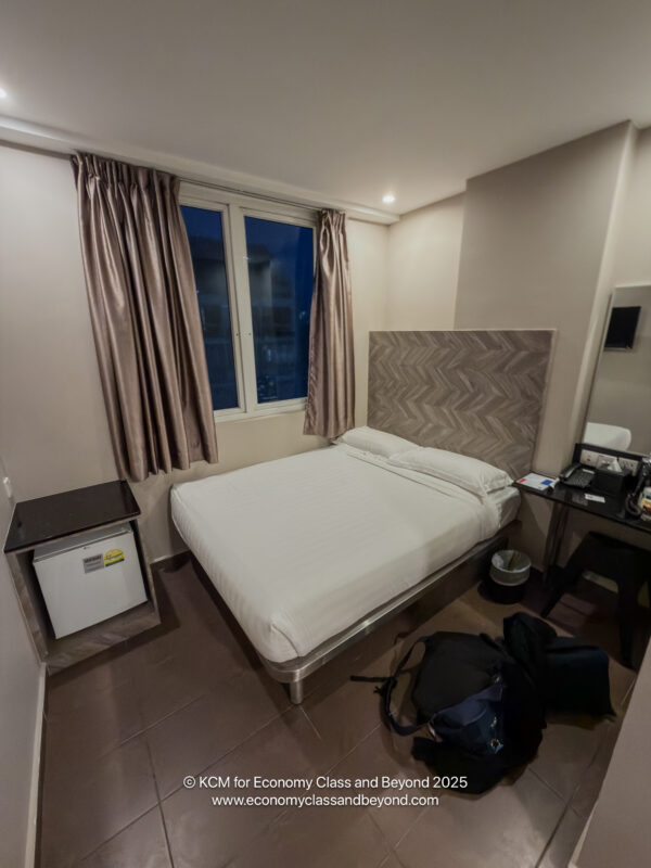 a room with a bed and a backpack