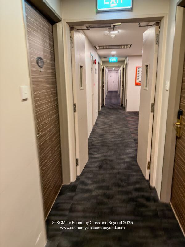 a hallway with doors and a sign