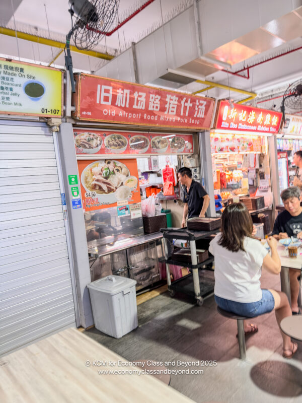 people sitting at a table in a food store
