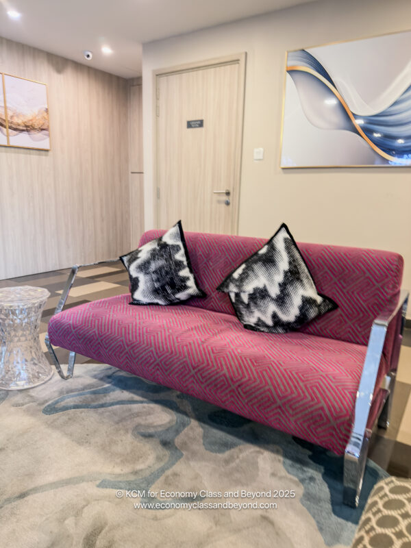 a pink couch with pillows on it