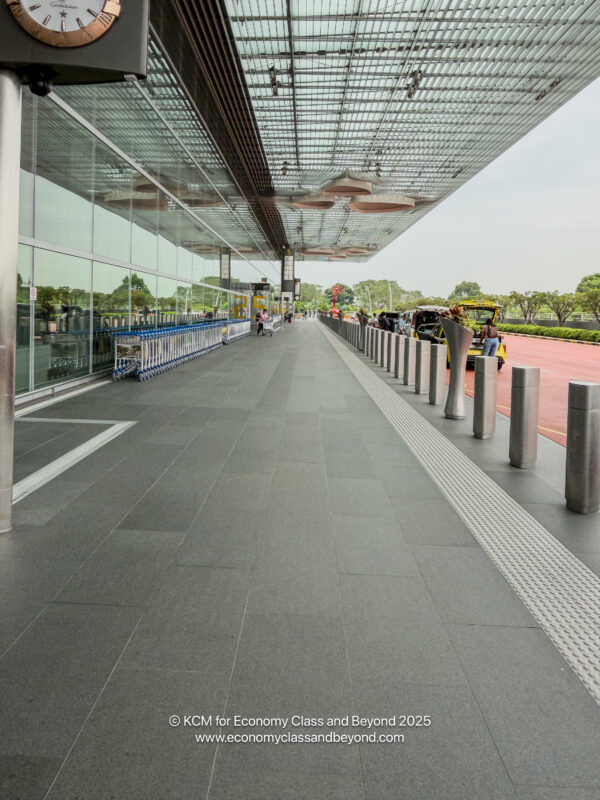 a building with a glass wall and a walkway