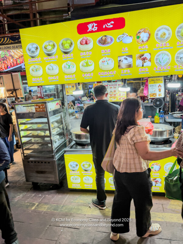 a group of people standing in a food market