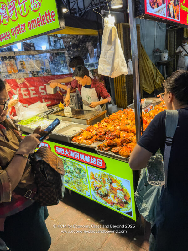 a woman standing in front of a food stand