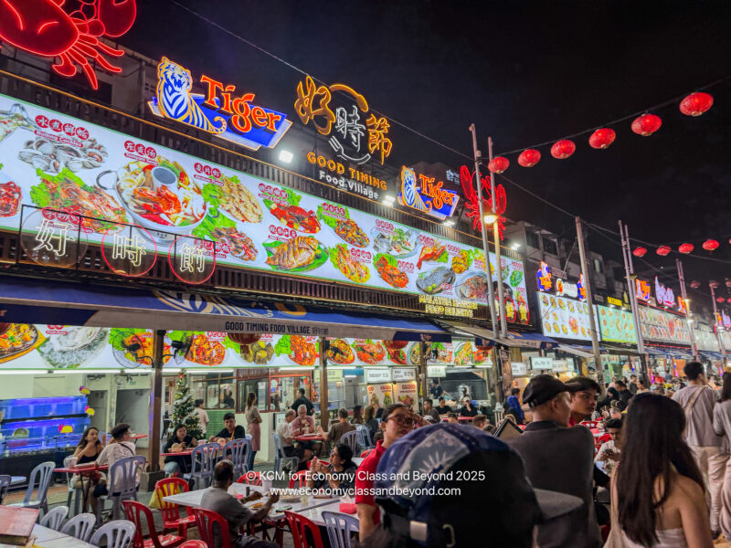 a group of people sitting at tables outside a restaurant