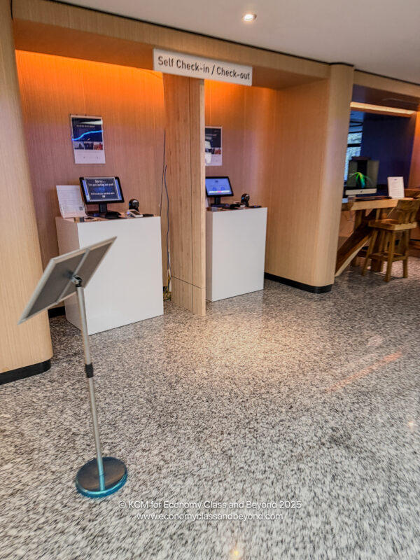 a room with a stand and computer screens