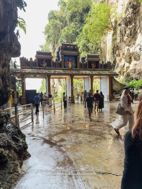 a group of people walking in a cave