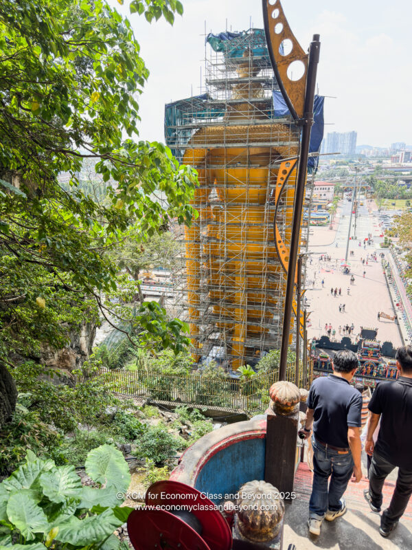 people walking down a hill with scaffolding