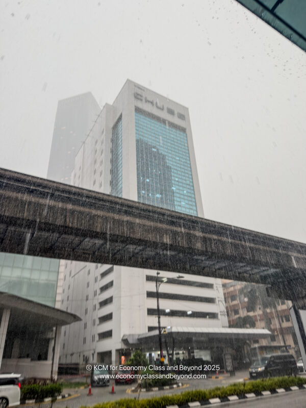 a bridge over a street with buildings in the background