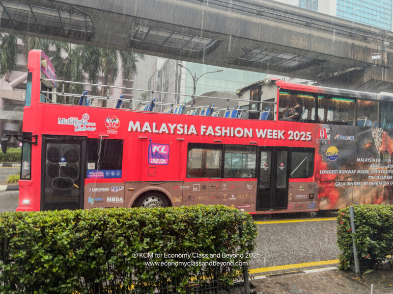 a red double decker bus on a rainy day