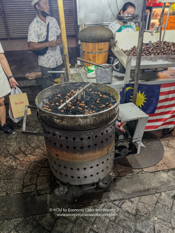 a large metal pot with a large barrel with food in it
