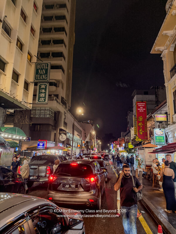 a street with cars and people in the city