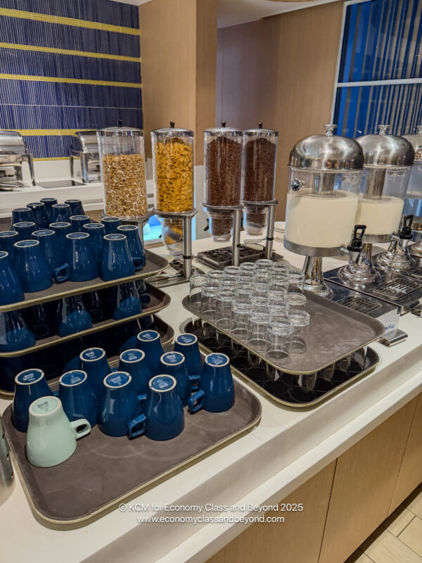 a table with different types of cereals and cups