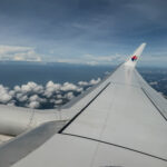 the wing of an airplane above clouds