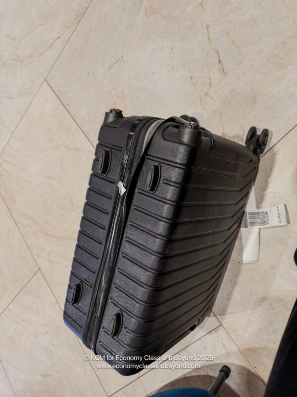 a black suitcase on a tile floor