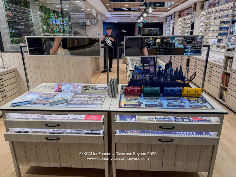 a man standing in front of a display of glasses