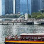 a boat on a body of water with a crowd of people on it