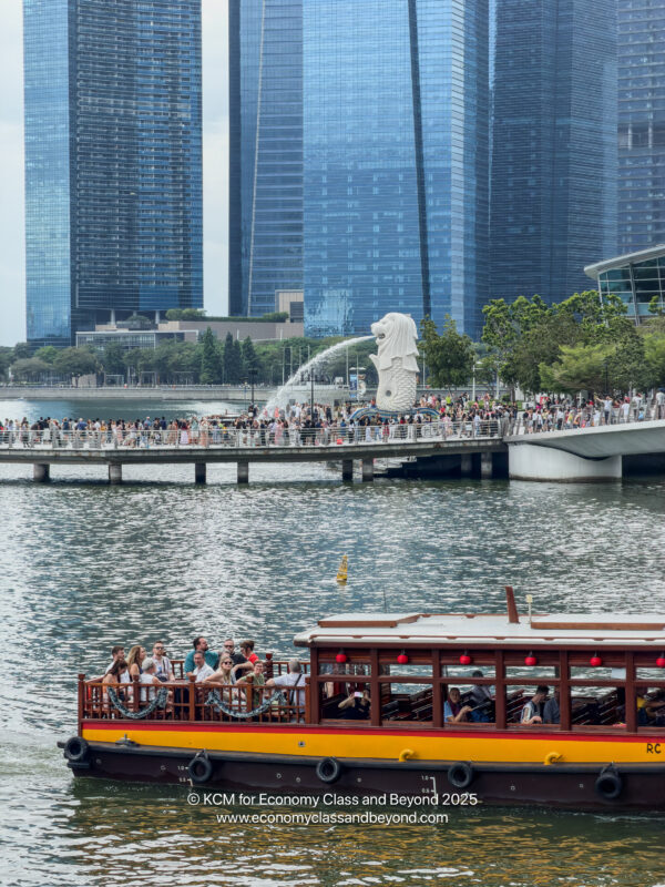 a boat on a body of water with a crowd of people on it
