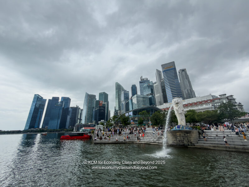 a water fountain with a statue in the middle of a city