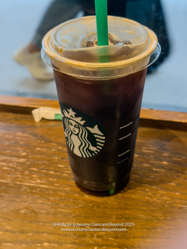 a plastic cup with a straw and a brown liquid in it