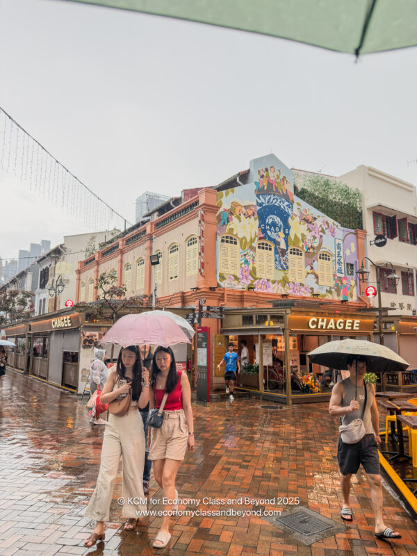people holding umbrellas in the rain