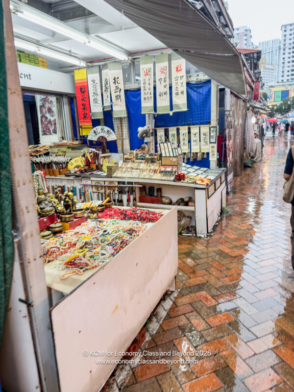 a street market with a few signs and a man walking