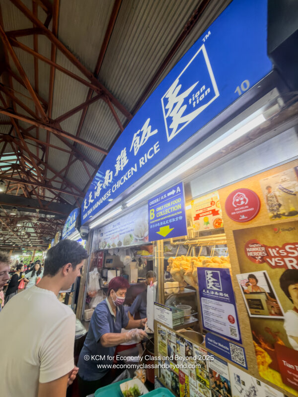 a man standing in front of a food stand