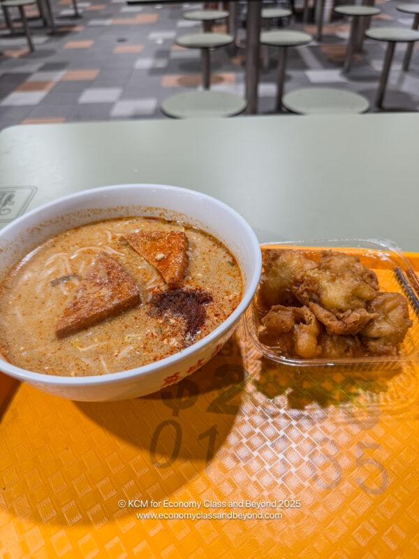 a bowl of soup and food in a plastic container